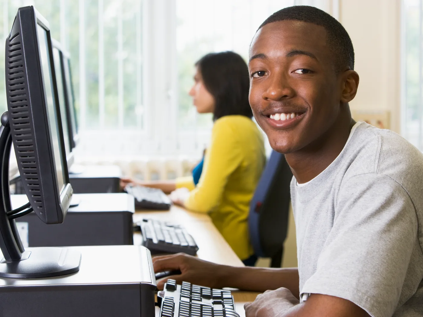 Students working at computers in a lab.