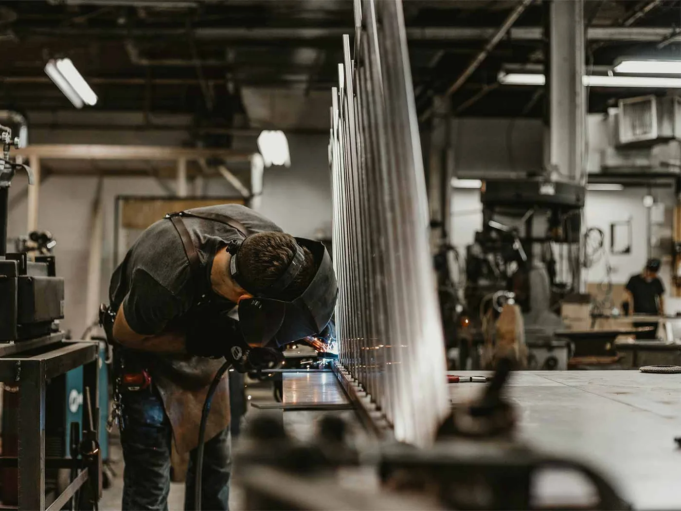 A welder at work on a metal fabrication.