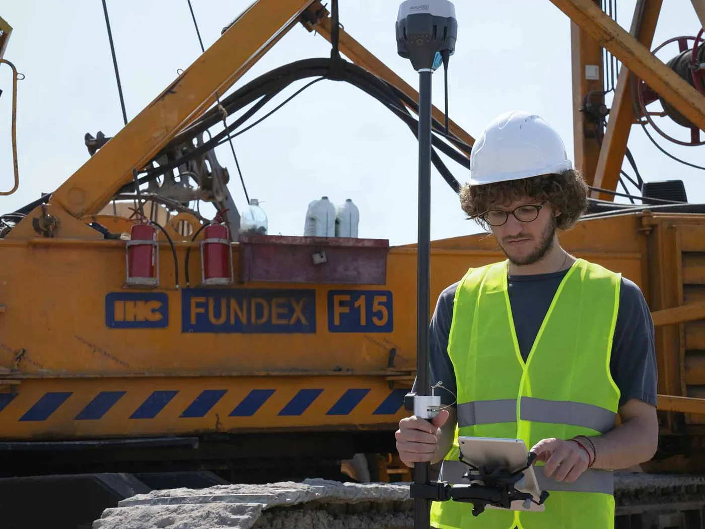 An engineer working alongside a trainee at a machine.
